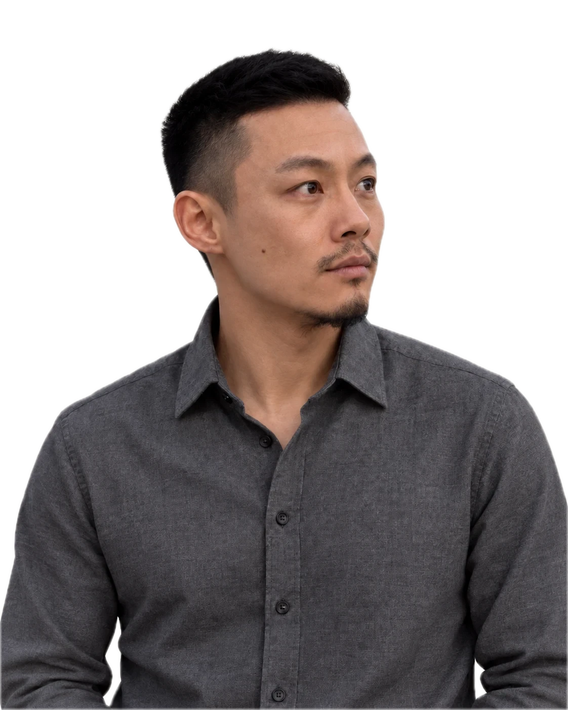 Dainer in a charcoal shirt, looking ahead